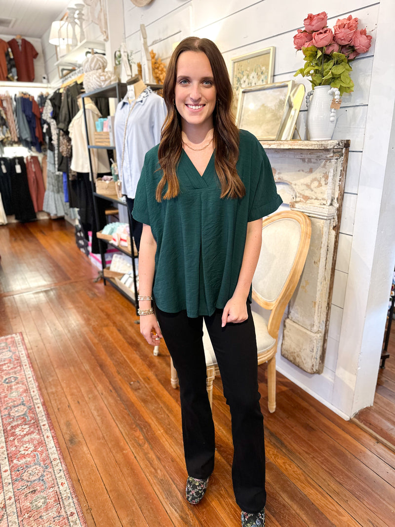 dark green rolled sleeve top with flowy fit 