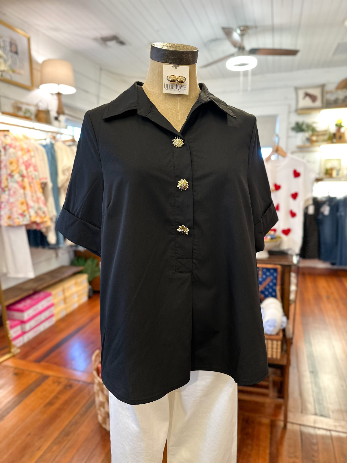 Black shirt on a mannequin in a store setting