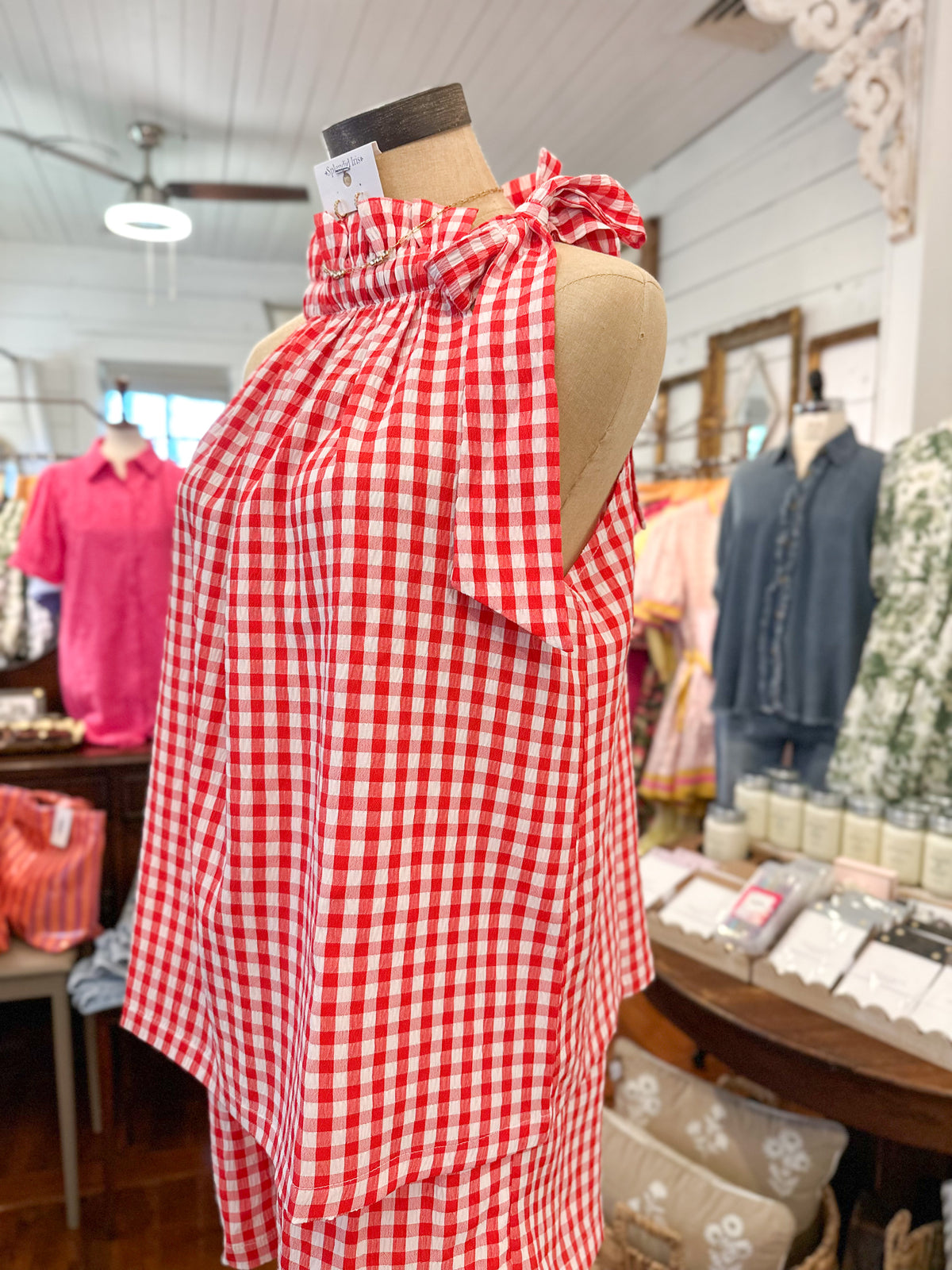 Red and white checkered dress on a mannequin in a store setting