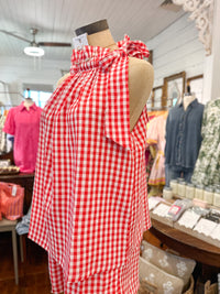 Red and white checkered dress on a mannequin in a store setting