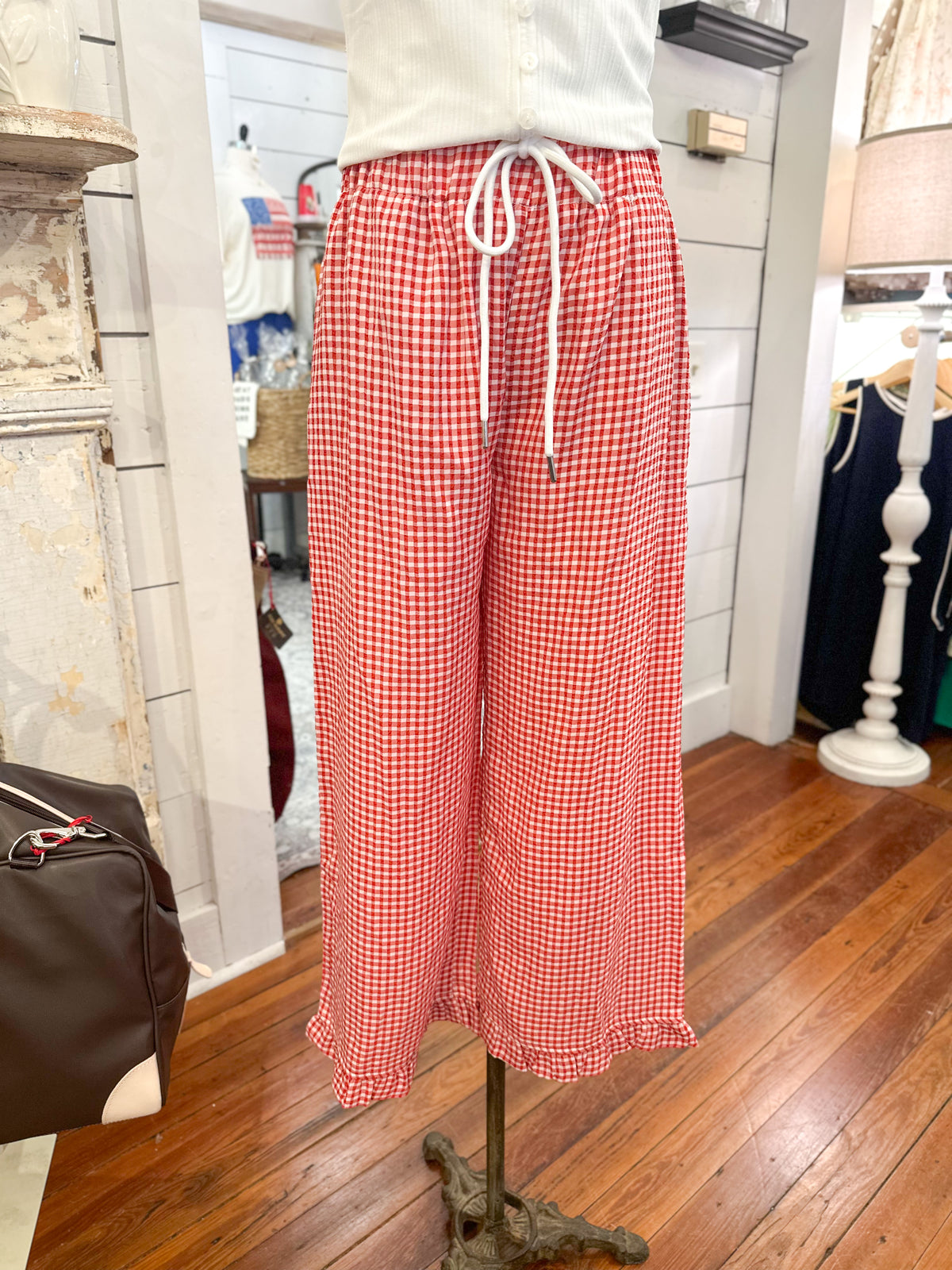Red checkered pants on a mannequin in a store setting