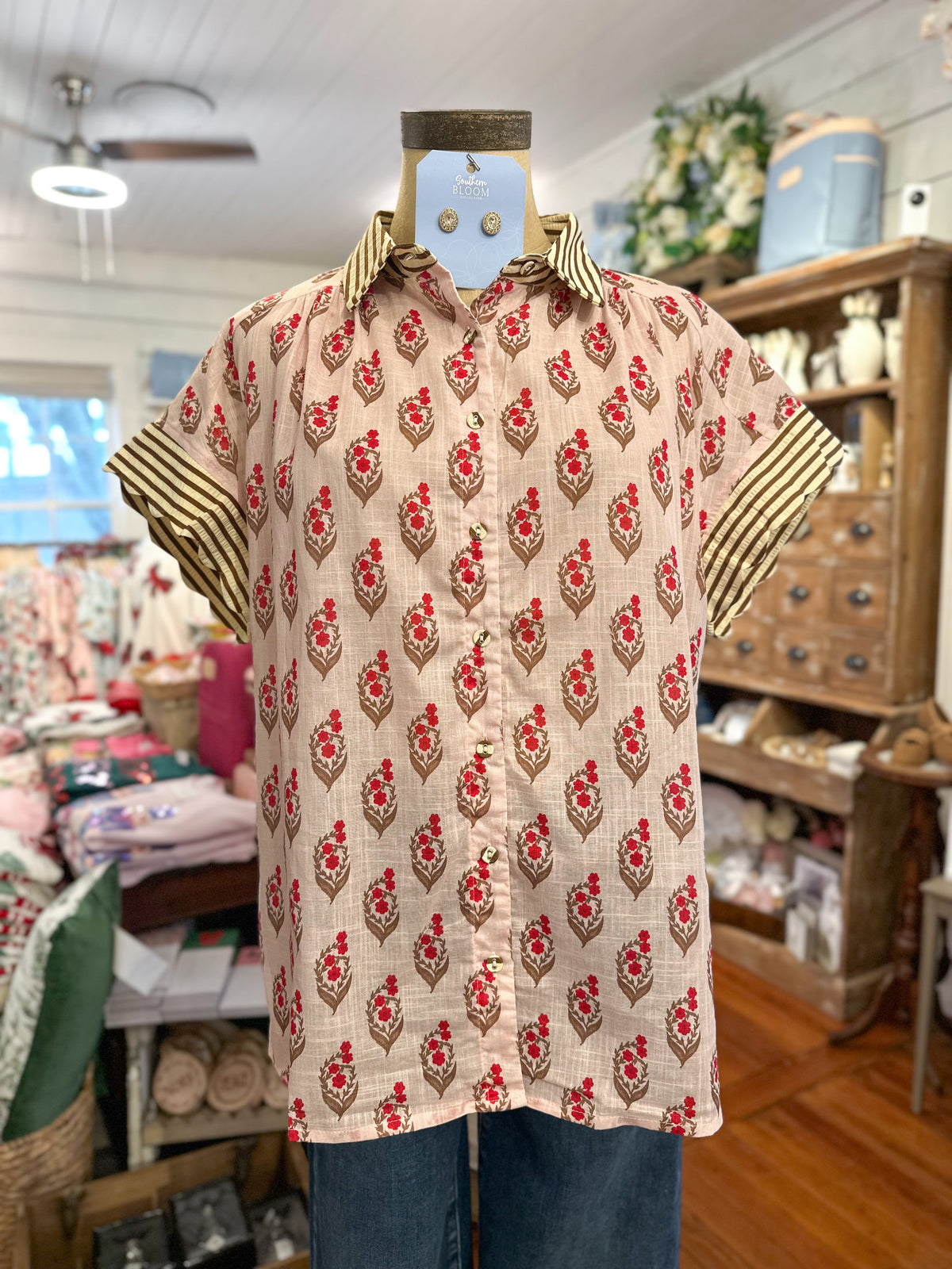 block print floral blouse with buttons cotton top inside store setting 