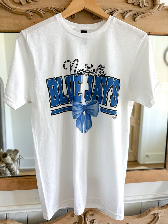 White t-shirt with 'Nashville Blue Jays' text and blue bow on a wooden hanger.