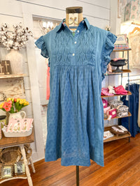 Blue dress on a mannequin in a store setting