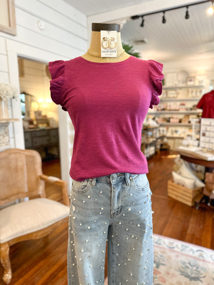Mannequin wearing a magenta top and light blue jeans in a store setting
another love top orchid pink 