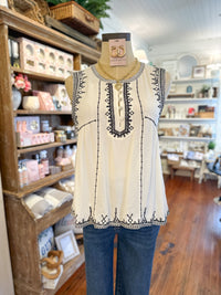 cream flowy tank top with black embroidery details 