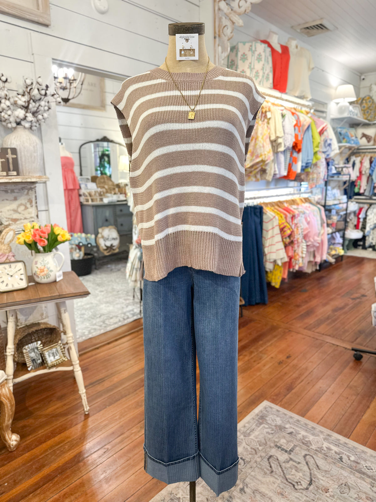 Mannequin wearing a striped sweater and jeans in a store setting