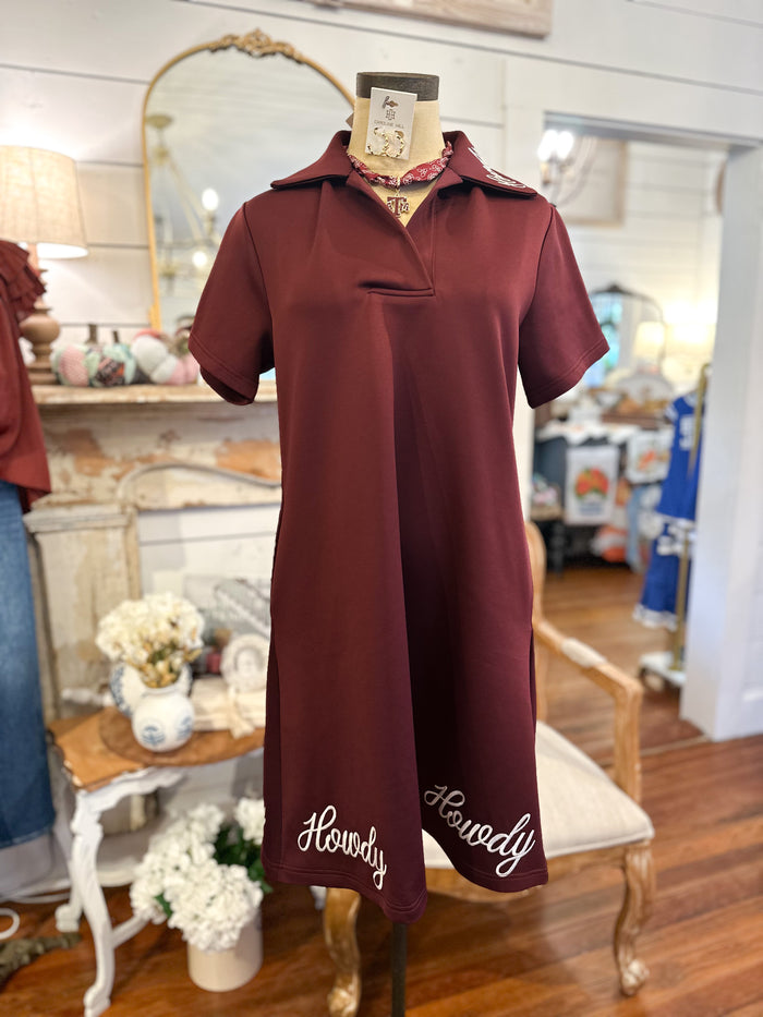 Maroon dress with 'Howdy' embroidery on a mannequin in a store setting.