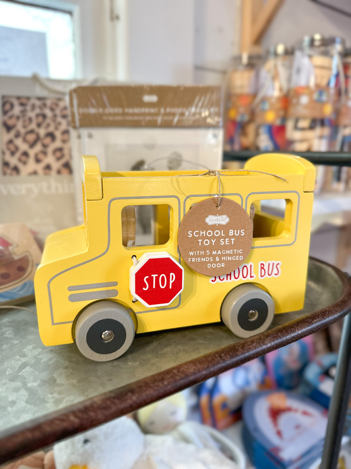 Yellow toy school bus with a stop sign on a shelf
