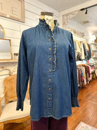 Blue denim shirt on a mannequin in a store setting