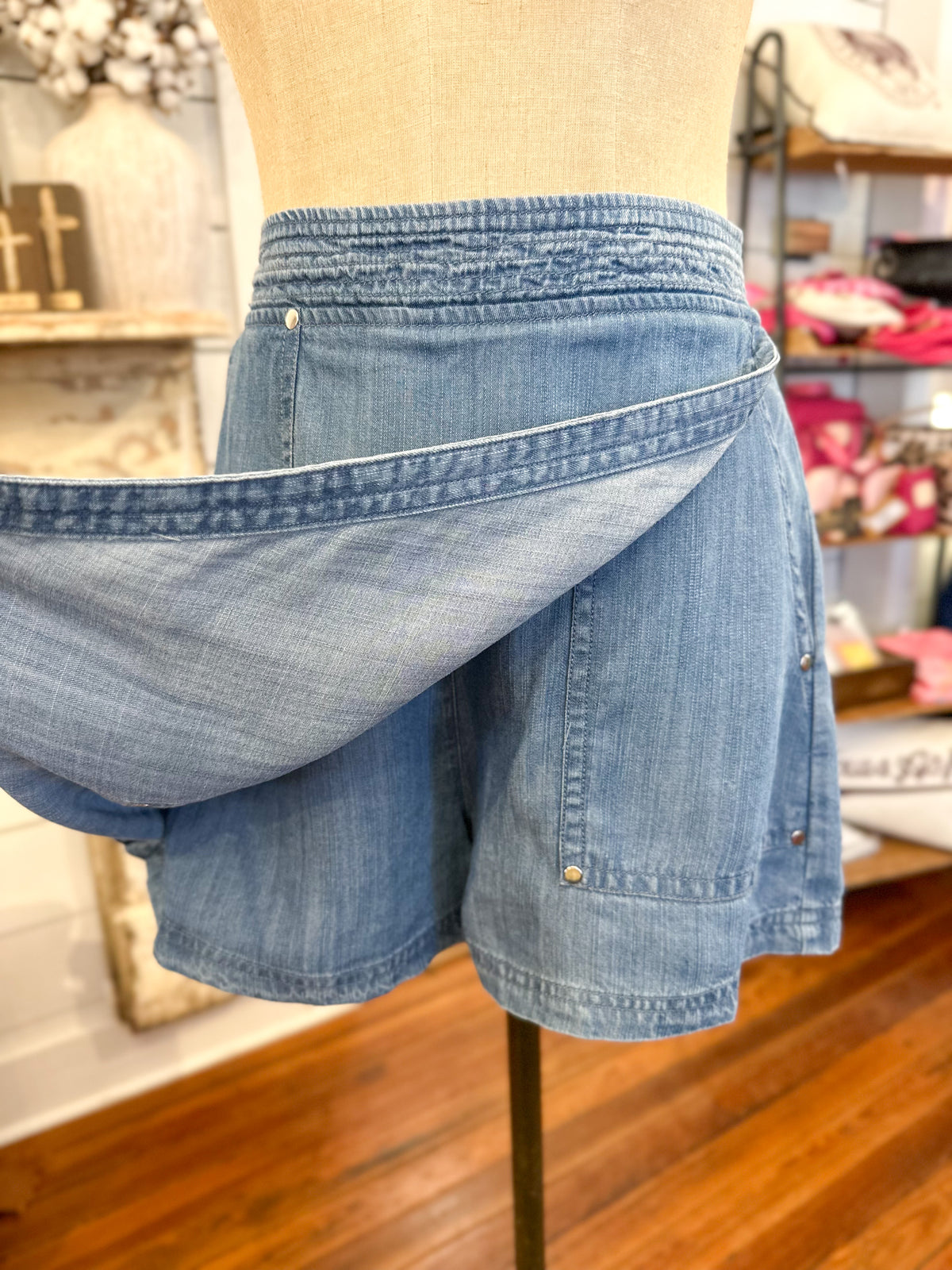 Blue denim shorts on a mannequin in a store setting