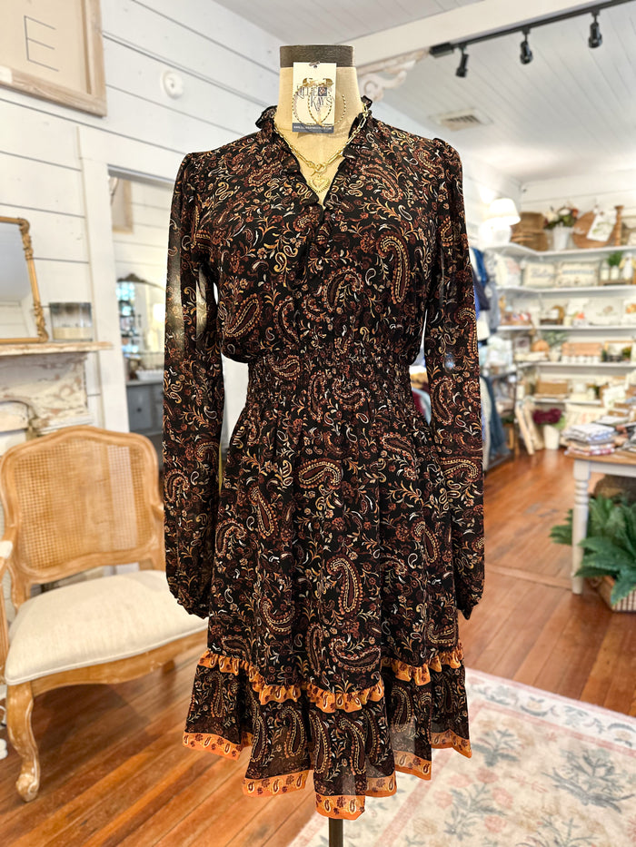Brown patterned dress on a mannequin in a store setting
