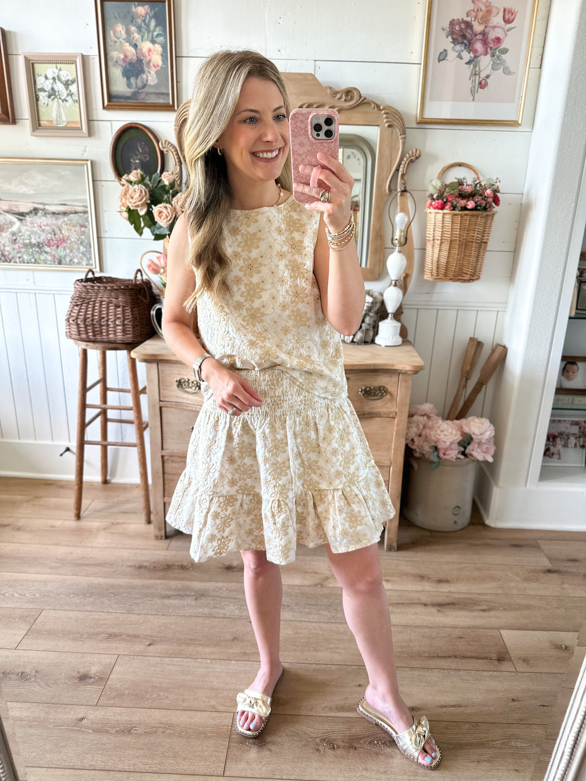 Woman taking a mirror selfie wearing matching top and skirt 