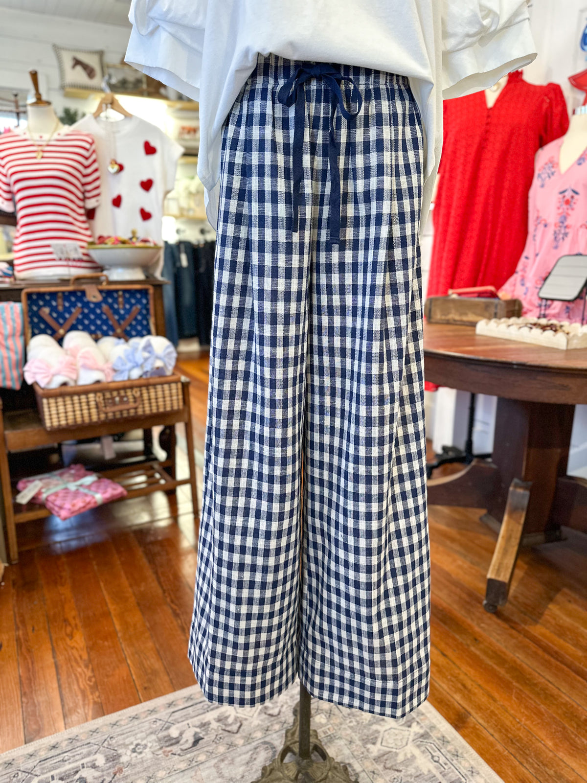 Mannequin wearing blue and white checkered pants in a store setting