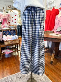 Mannequin wearing blue and white checkered pants in a store setting