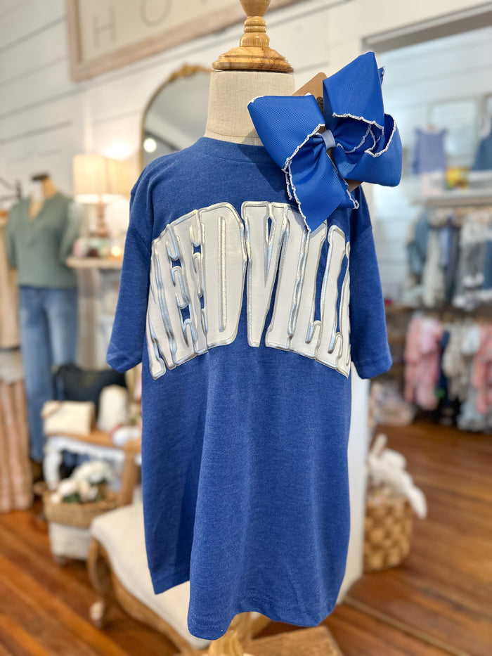 Blue TEEwith white text and a large blue bow on a mannequin in a store setting.
NEEDVILLE BLUE JAYS