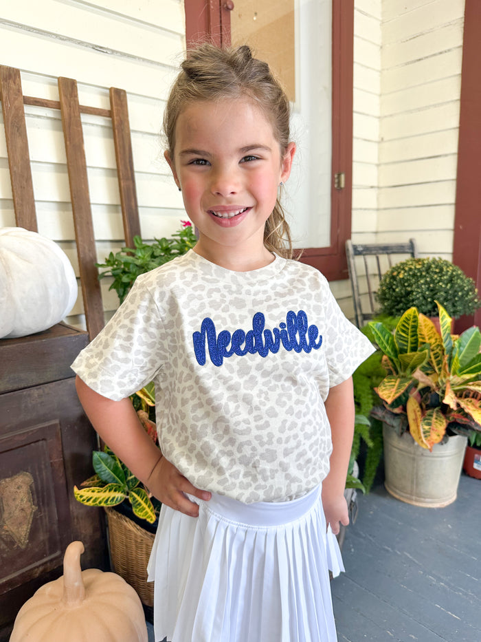needville print tee with royal blue glitter design 