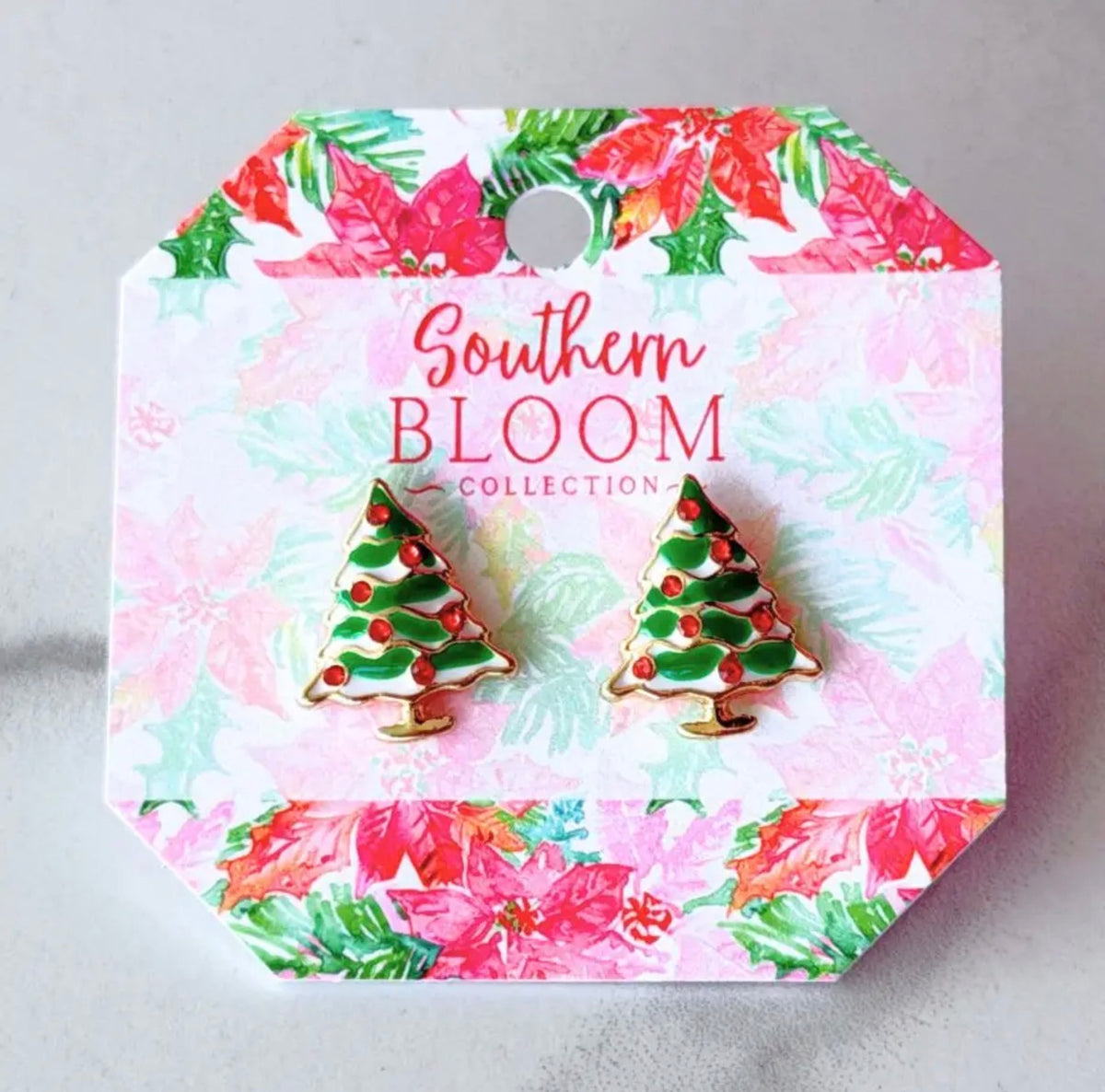 A pair of Christmas tree stud earrings in green enamel with red berry accents, displayed on a branded card backing that reads 'Southern BLOOM COLLECTION'.