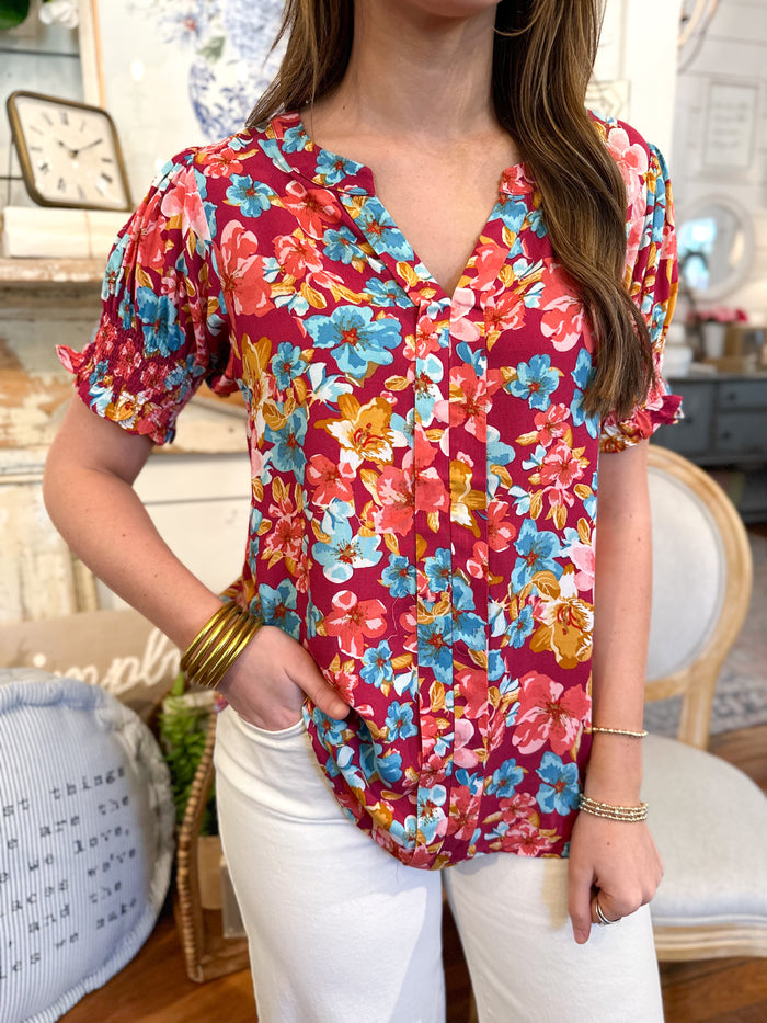 connie top washco apparel, multi color floral top short sleeve with elastic around arm. 