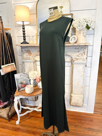 Green dress on a mannequin in a room with a fireplace and decor items.