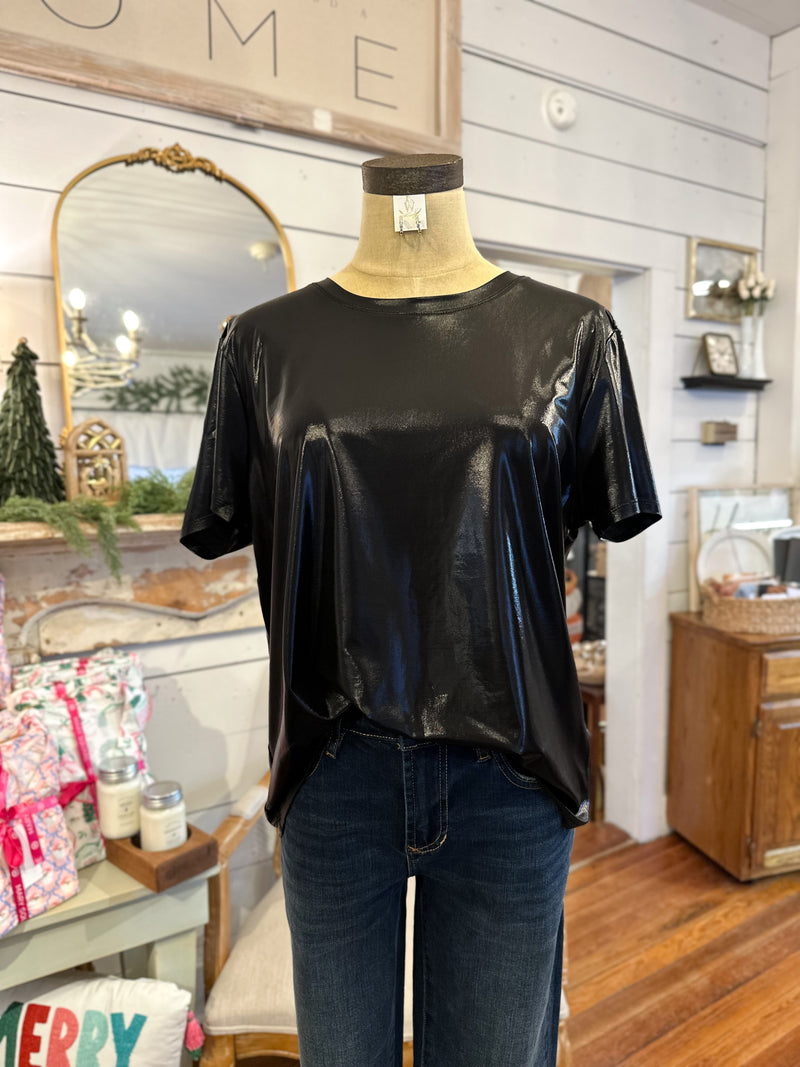 Black shiny top on a mannequin in a home interior setting
dear john unity top 