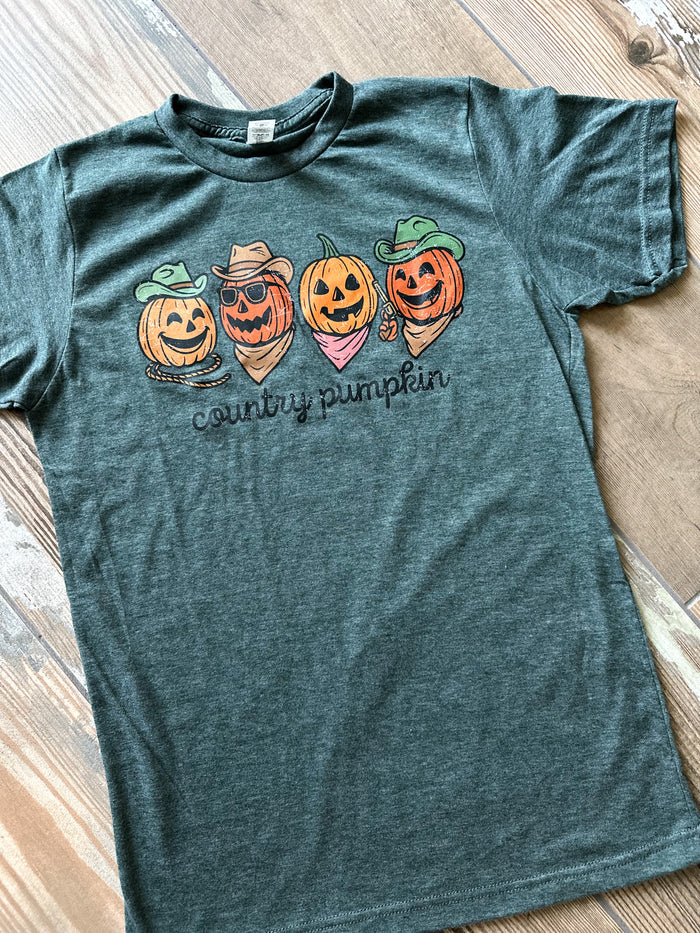 Green t-shirt with Halloween-themed pumpkins design on a wooden surface