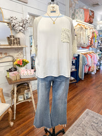 Mannequin wearing a white top and blue jeans in a store setting