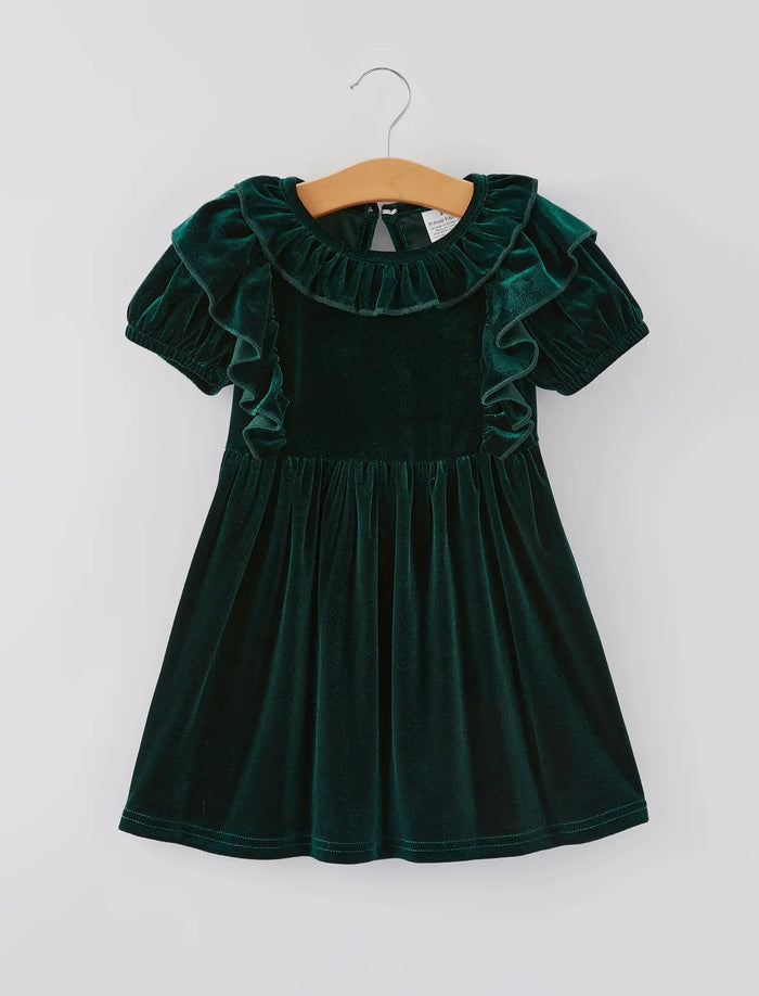 Green velvet dress with ruffled collar on a hanger against a white background
