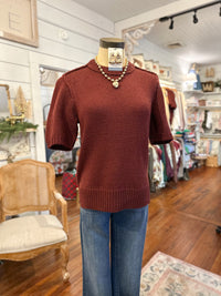 Mannequin wearing a brown sweater and blue jeans in a store setting