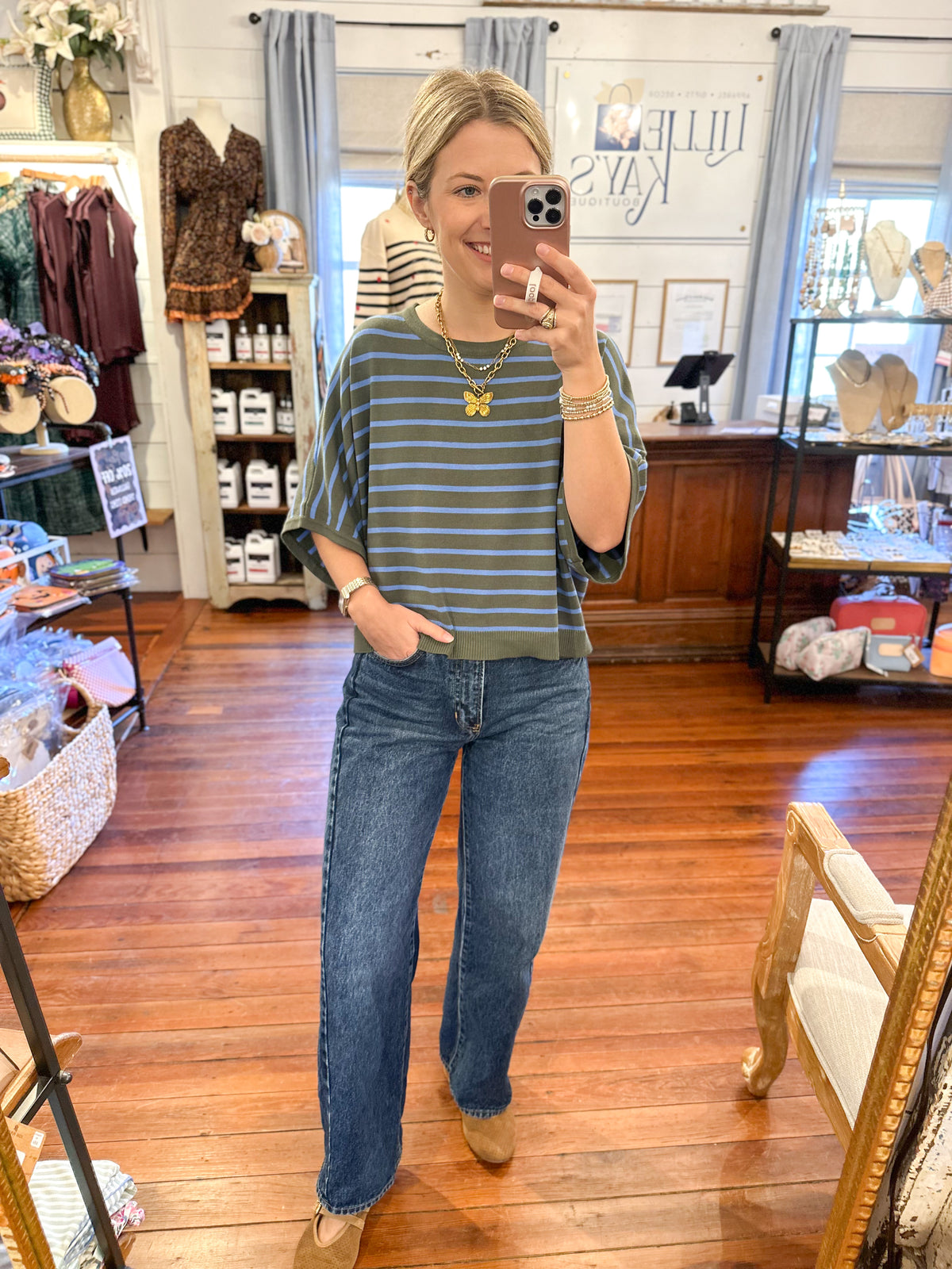 blue and green relaxed sweater top 
in store setting 