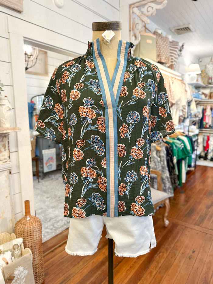 Floral patterned top on a mannequin in a store setting
