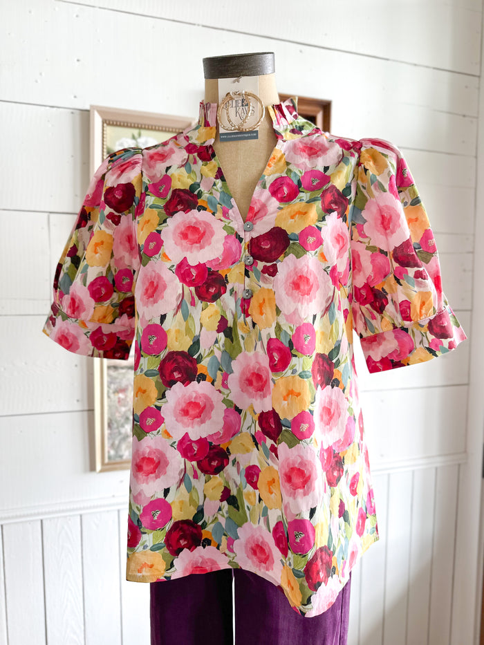 Floral blouse on a mannequin against a white wall