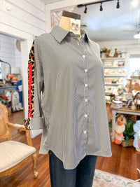 Mannequin wearing a black and white striped shirt in a store setting