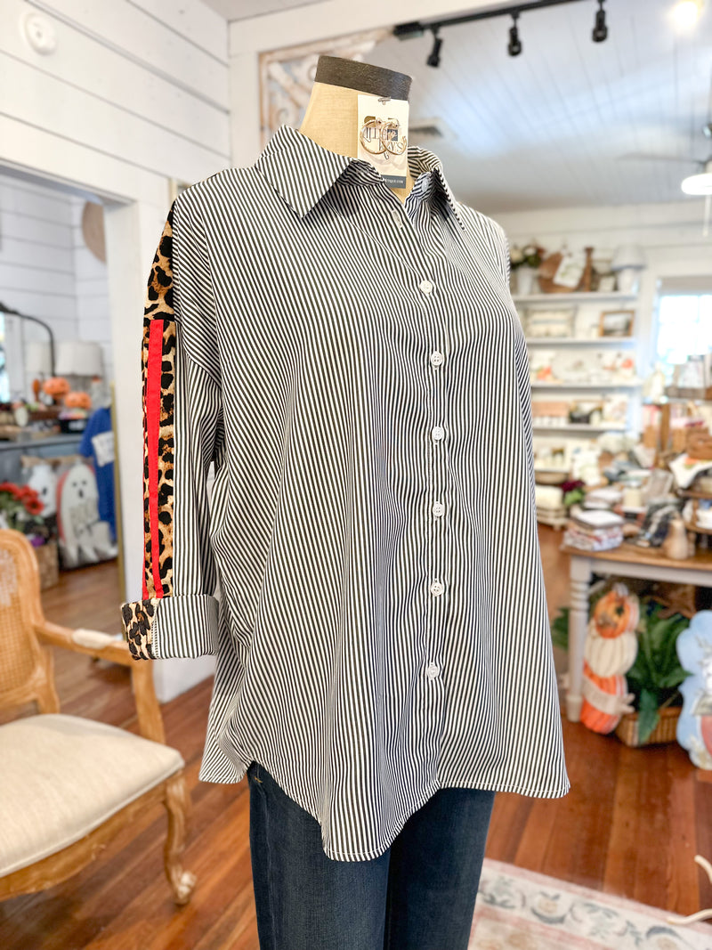 Mannequin wearing a black and white striped shirt in a store setting