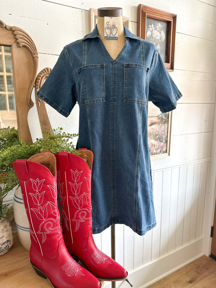 Blue denim dress on a mannequin with red cowboy boots in a home setting.