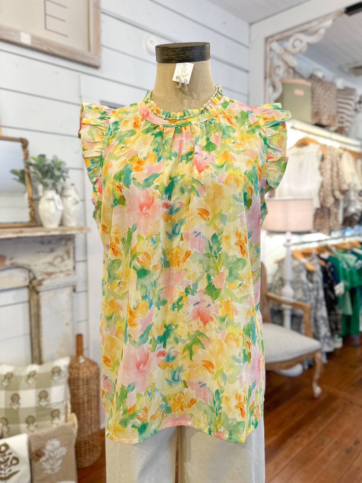 Floral top on a mannequin in a store setting