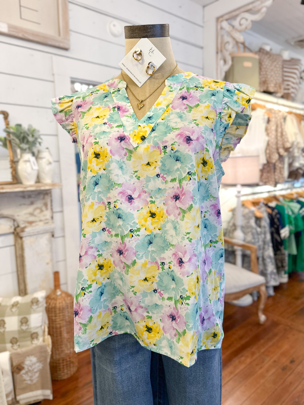 Floral blouse on a mannequin in a store setting
