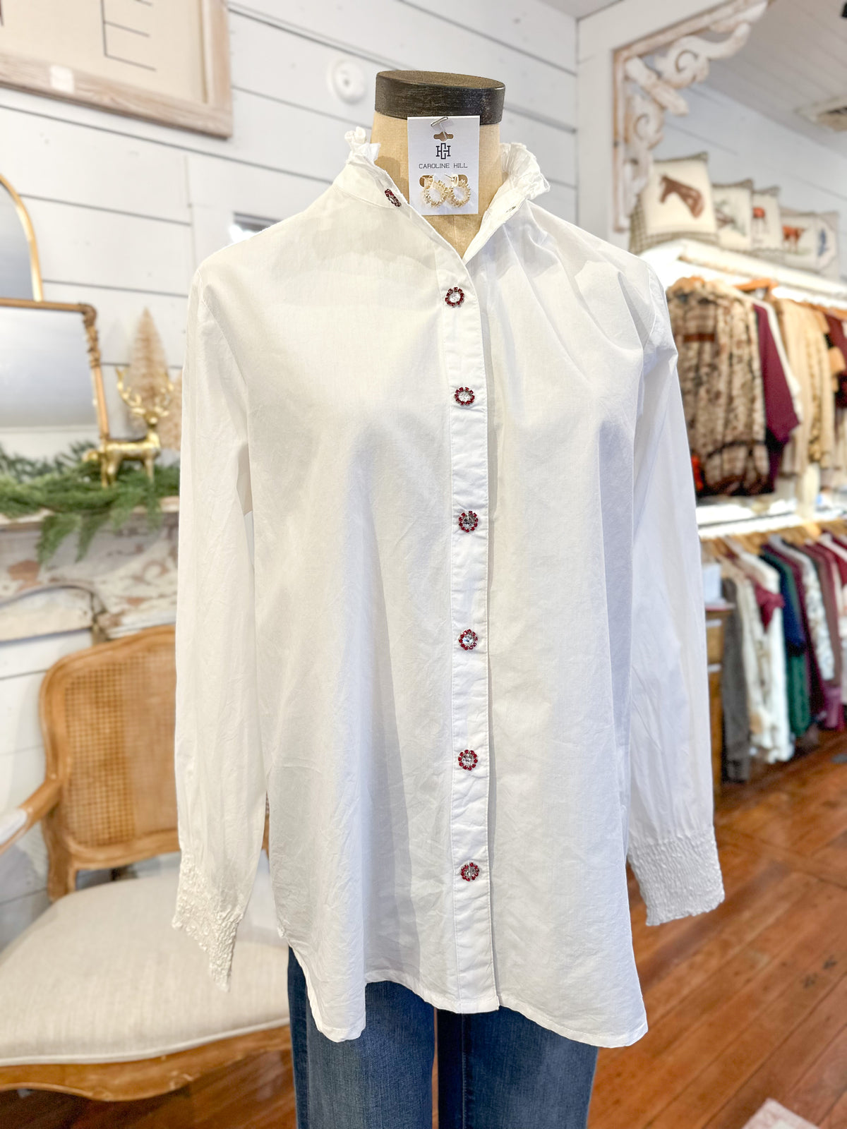 White button-up shirt on a mannequin with a tag in a store setting layerz clothing white renee top 