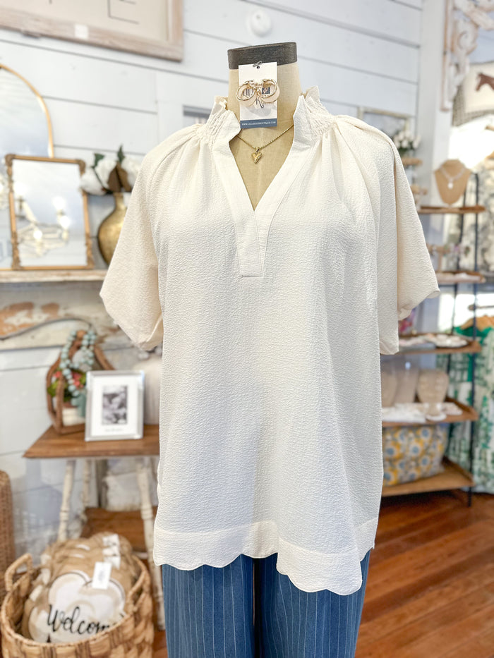 White blouse on a mannequin with a blurred store interior background