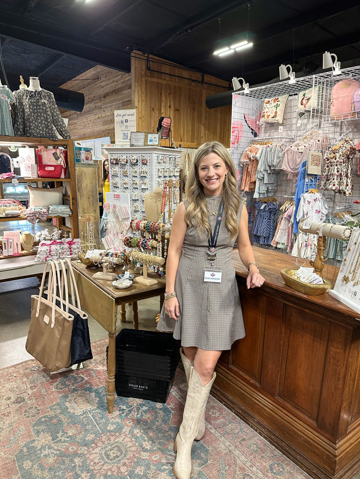 person wearing dress with boots in store setting 
