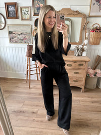 black matching loungewear set with top  and bottom with side contrast in cream 
