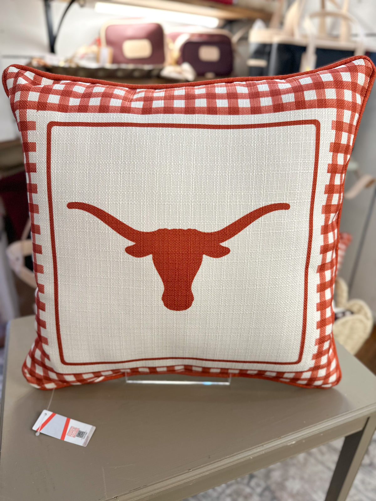 Decorative pillow with a longhorn design on a table