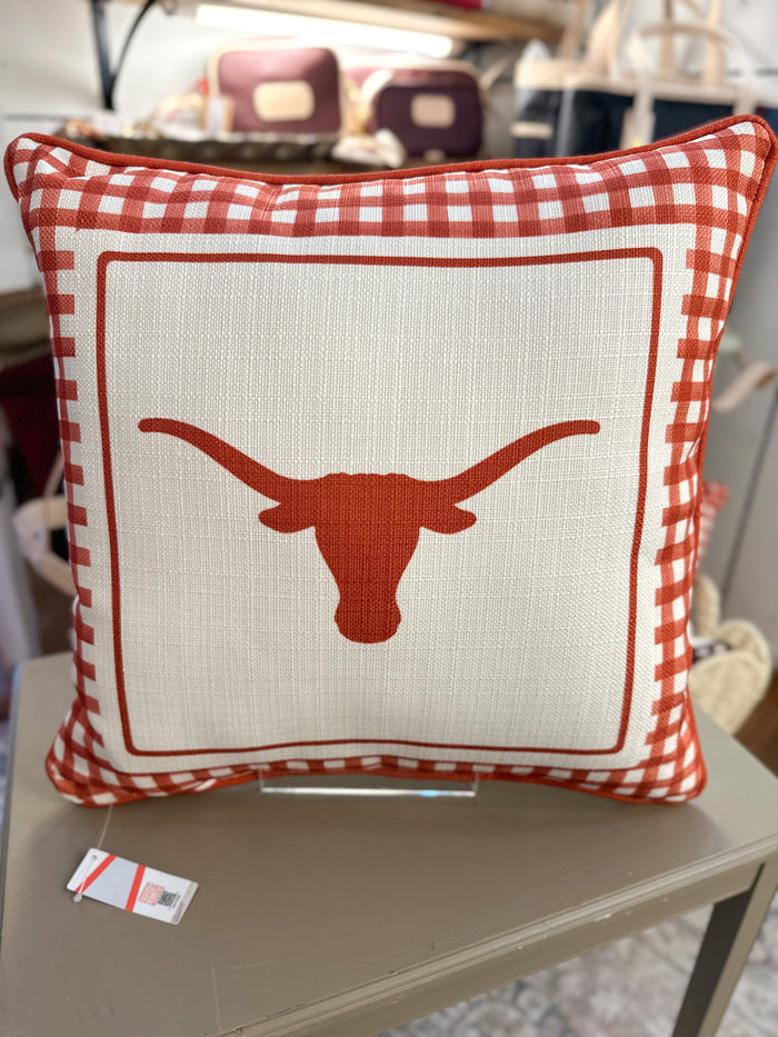 Decorative pillow with a longhorn design on a table