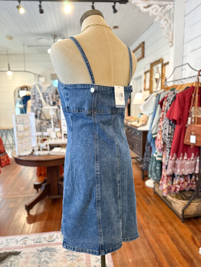 Denim button front dress on a mannequin in a store setting