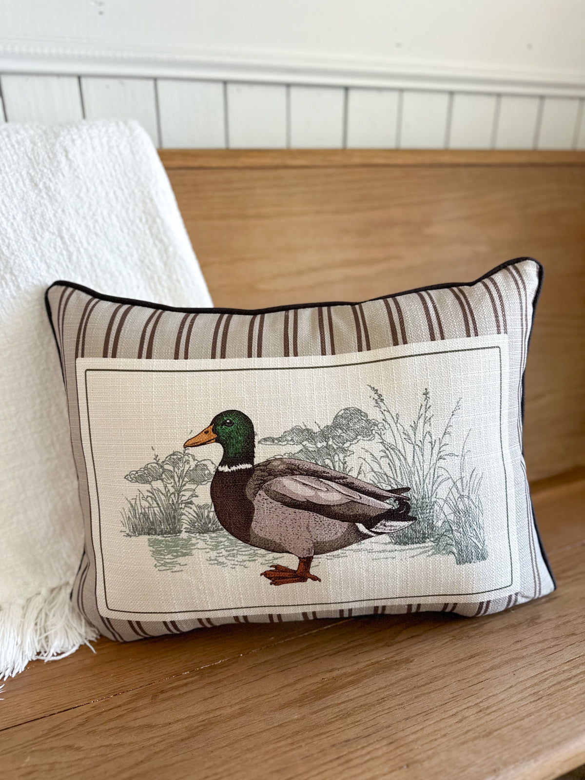Decorative pillow with a duck design on a wooden surface