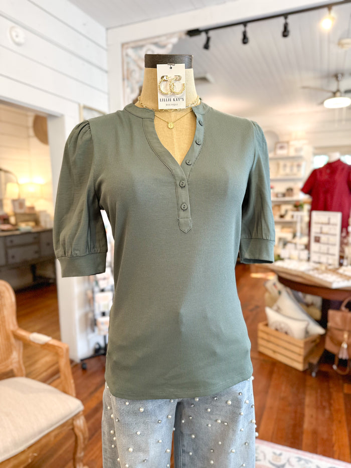 Green shirt on a mannequin in a store setting tanner top another love 