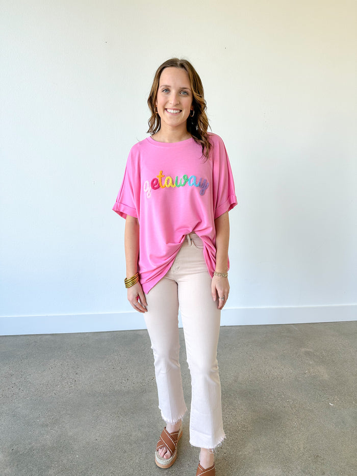 mud pie getaway pink tee with multi color patches on the front