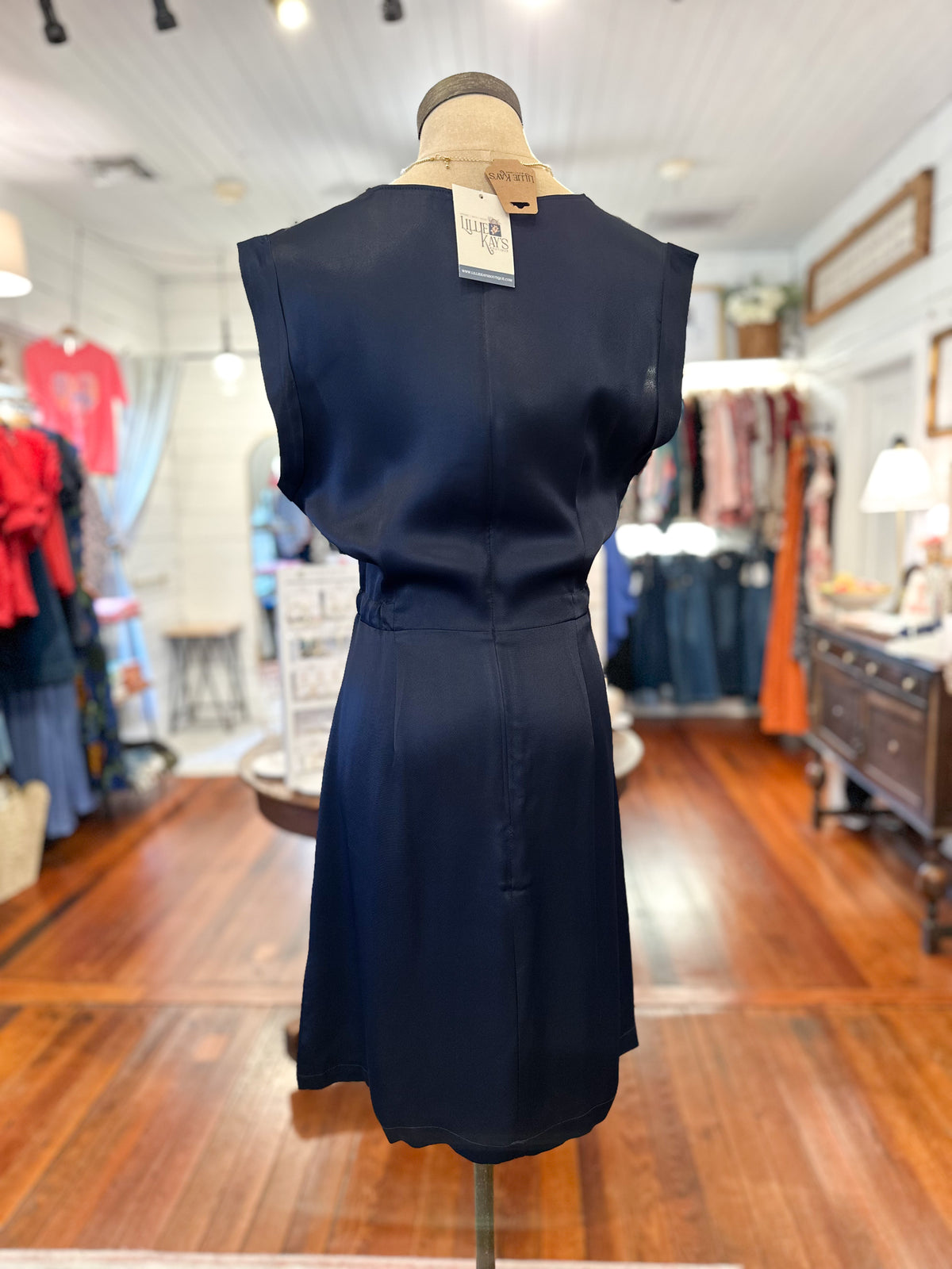 Navy blue dress on a mannequin in a store setting