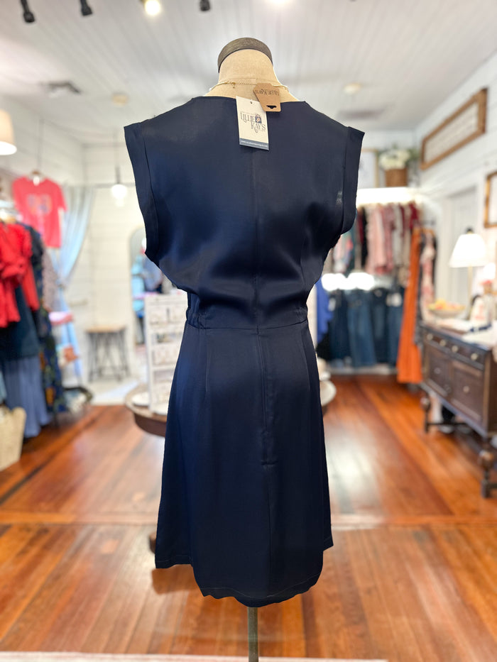 Navy blue dress on a mannequin in a store setting