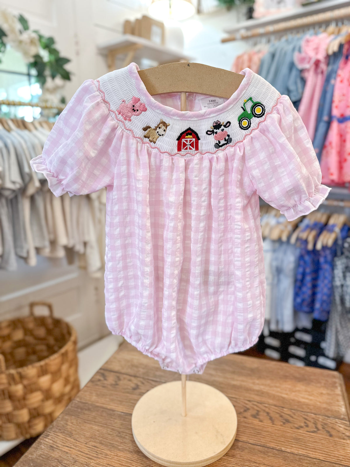 baby size pink checkered bubble romper with farm them along collar line 